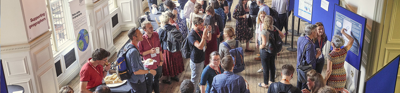 Conference attendees eating, networking and looking at posters on display in the Society's Main Hall