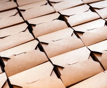 Folded cardboard boxes stacked in rows