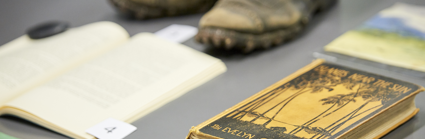 Display of historic materials including worn boots and books