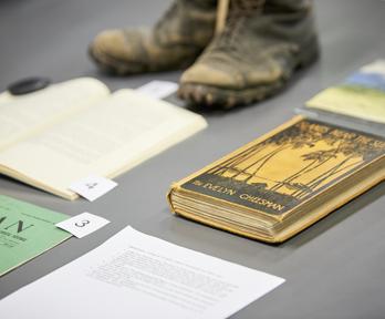 Display of historic materials including worn boots and books