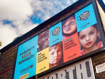 Unicef billboard that reads "Humanity needs humanity" with pictures of children