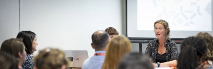 Discussion session at a conference, showing presenters and audience