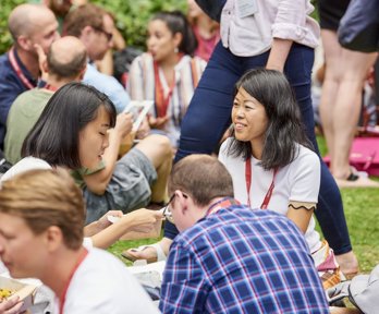 Conference delegates networking over lunch in the garden