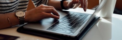 Person seated at the table using laptop