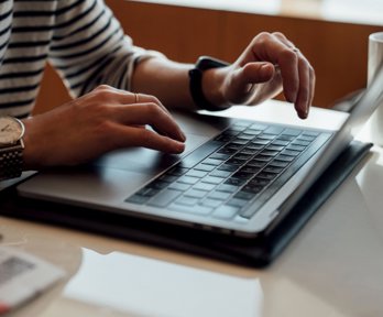 Person seated at the table using laptop