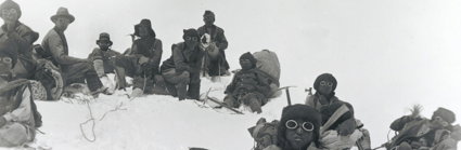 Historic black and white photograph of Sherpa climbers with mountaineering equipment on Mount Everest