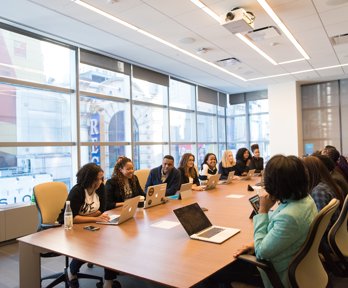 Professionals on a long table having a meeting