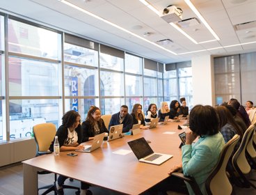 Professionals on a long table having a meeting