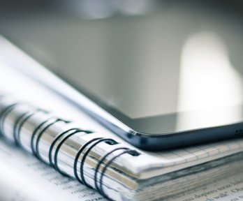 Tablet or phone on top of a notebook