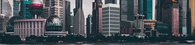 A view of a Chinese city, showing skyscrapers and modern buildings on the banks of a river